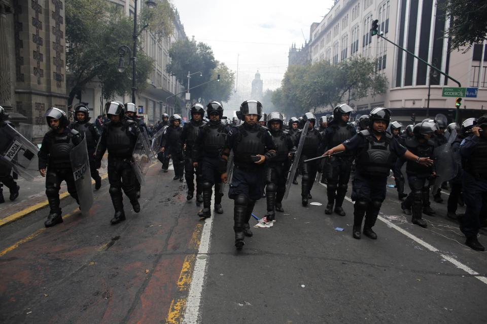 Riot policemen walk towards the Zocalo after protesters had been given a deadline to evacuate the Zocalo in Mexico City September 13, 2013. (REUTERS/Tomas Bravo)