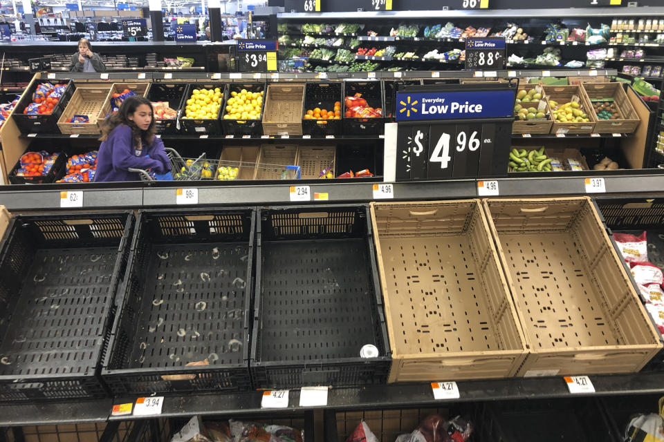 Display baskets are nearly empty in the produce section of a Walmart in Warrington, Pa., Tuesday, March 17, 2020. Concerns over the new coronavirus have led to consumer panic buying of grocery staples in stores across the country. (AP Photo/Matt Rourke)