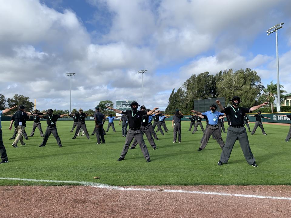 The aspiring umpires at the instructional camp in Vero Beach practice making definitive, emphatic signals in large groups. (Photo by Hannah Keyser, Yahoo Sports)