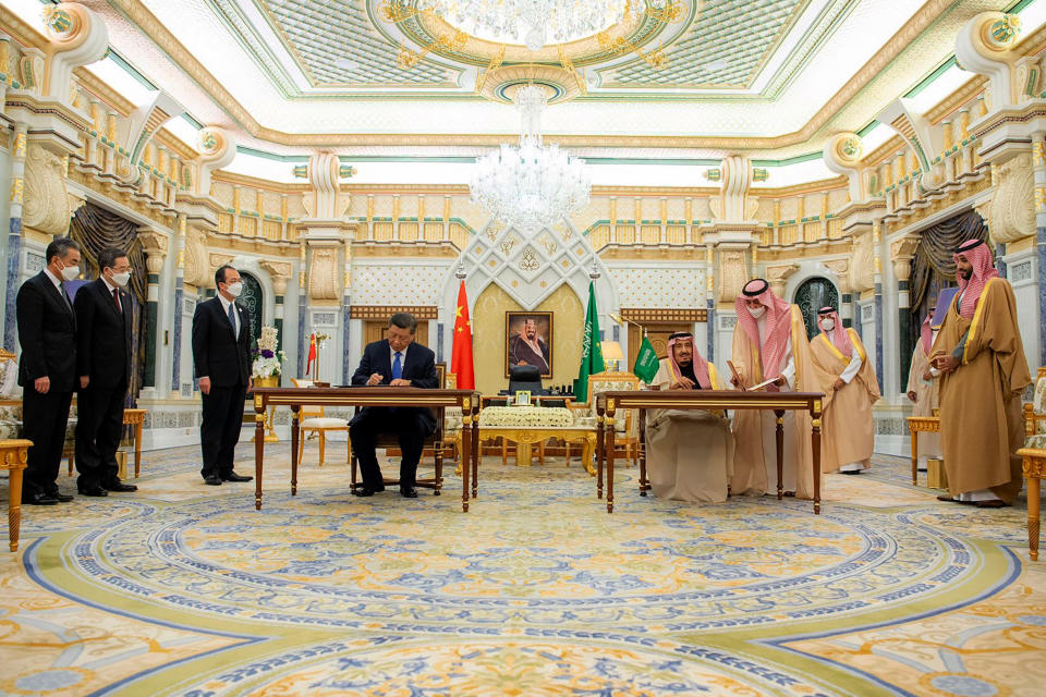 In this photo made available by Saudi Press Agency, SPA, Chinese President Xi Jinping, sitting left, signs a document, next to Saudi King Salman, in Riyadh, Saudi Arabia, Thursday, Dec. 8, 2022. (Saudi Press Agency via AP)
