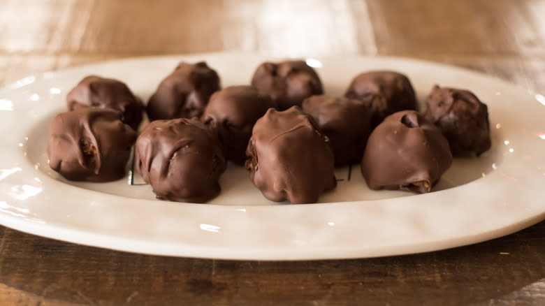 Chocolate bourbon balls on a white plate