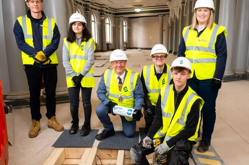 Burying a time capsule at Hull Maritime Museum - from left, Robin Diaper, curator of maritime and social history; Niamh Bonnar, service user at CASE; Lord Mayor of Hull Councillor Kalvin Neal; Dan Cook, service user at CASE; Alfie Wallis, apprentice at contractors Simpson, and Gillian Osgerby, programme director at Hull City Council -Credit:maritimehull.co.uk