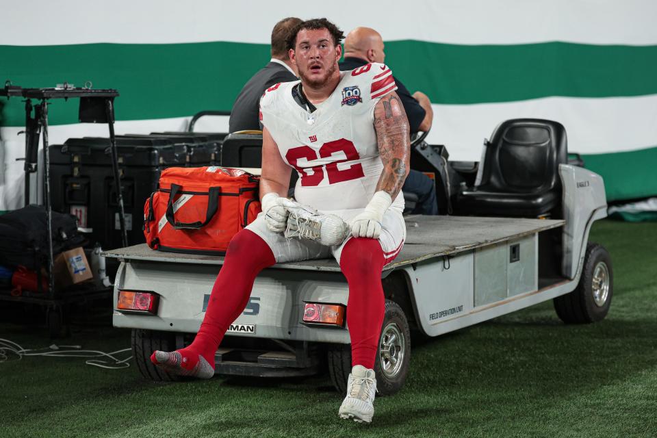 Aug 24, 2024; East Rutherford, New Jersey, USA; New York Giants guard Jalen Mayfield (62) is carted off the field after an injury during the second half against the New York Jets at MetLife Stadium. Mandatory Credit: Vincent Carchietta-USA TODAY Sports