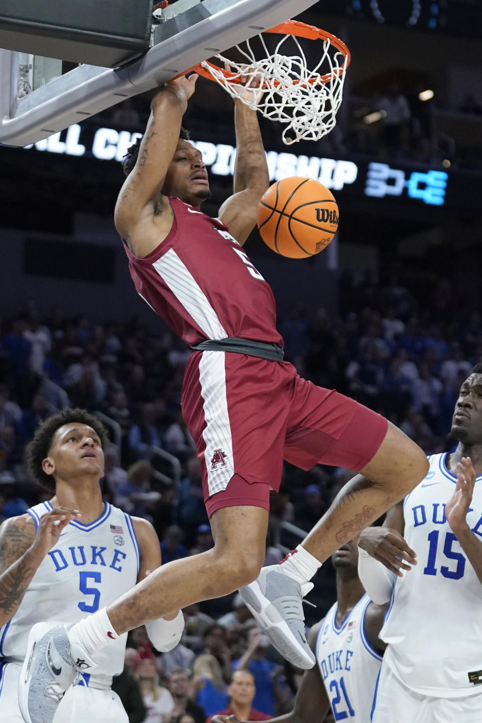 Arkansas guard Au'Diese Toney, top, dunks against Duke during the second half of a college basketball game in the Elite 8 round of the NCAA men's tournament in San Francisco, Saturday, March 26, 2022. (AP Photo/Marcio Jose Sanchez)