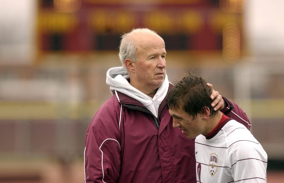 Arlington High school boys soccer coach Gary Montalto with his forward Cody Farrier after the team's loss to Newburg in LaGrange on Nov. 14, 2009.