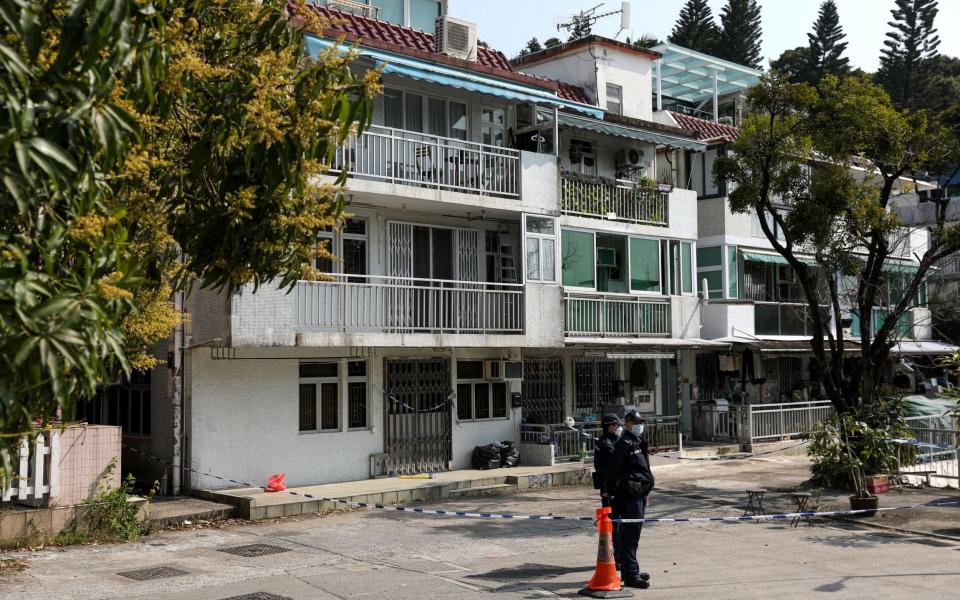 Police stand guard outside the house where Ms Choi's remains were found - JEROME FAVRE/EPA-EFE/Shutterstock