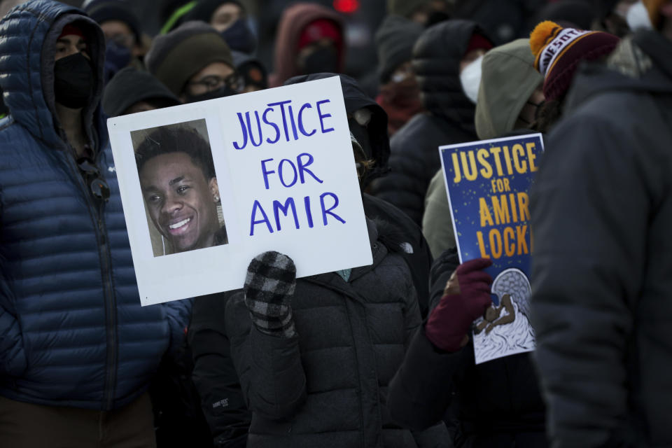 A protester holds a sign demanding justice for Amir Locke at a rally on Saturday, Feb. 5, 2022, in Minneapolis.  / Credit: Christian Monterrosa / AP