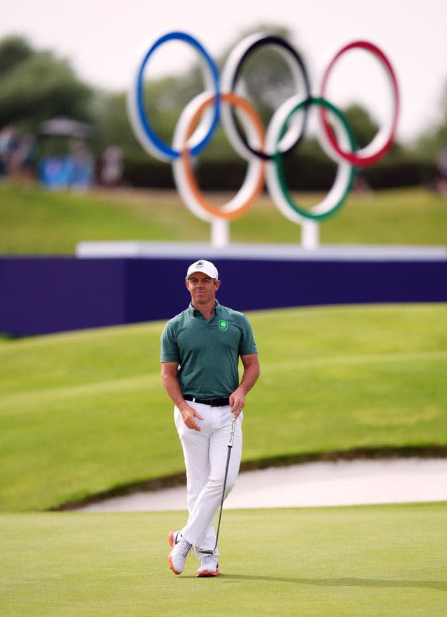 Rory McIlroy stands in front of the Olympic rings