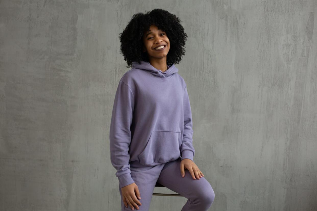 black woman in purple hoodie