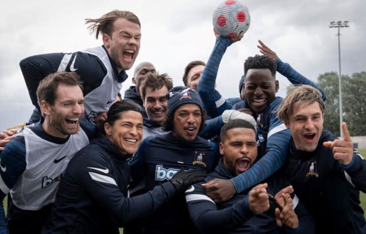 Male soccer players celebrate in Ted Lasso.