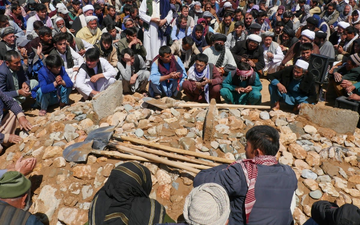 Afghans mourn at a burial ceremony of the slain Shiite Muslims after gunmen attacked a mosque in Guzara district of Herat province (AFP via Getty Images)