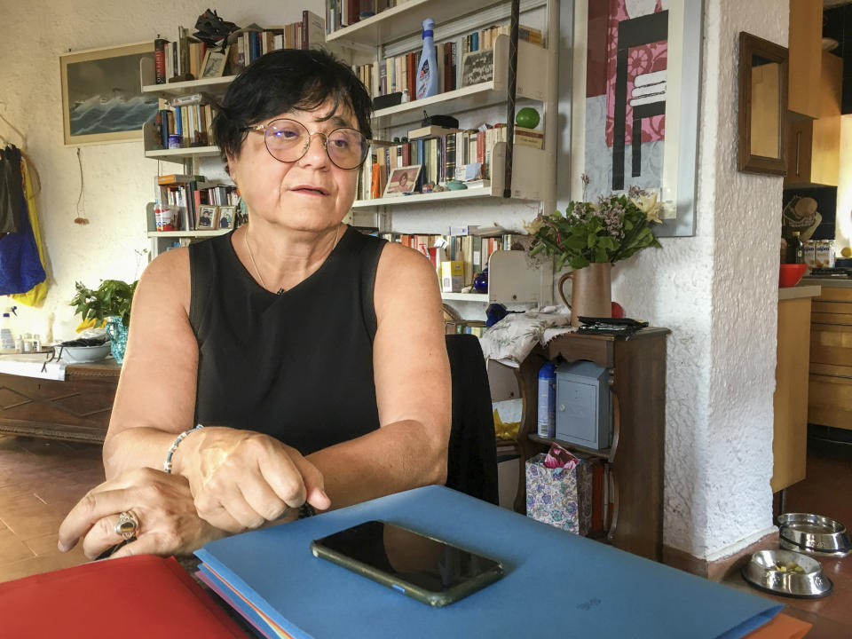 Italian scientist Paola Muti talks with the Associated Press during an interview in his studio at the Giglio Island, Italy, Tuesday, June 23, 2020. Muti was stranded on the tiny island where mainlanders sick with COVID-19 came ashore but no islanders apparently took ill. So she decided to do a scientific study to find out why. (AP Photo/Paolo Santalucia)