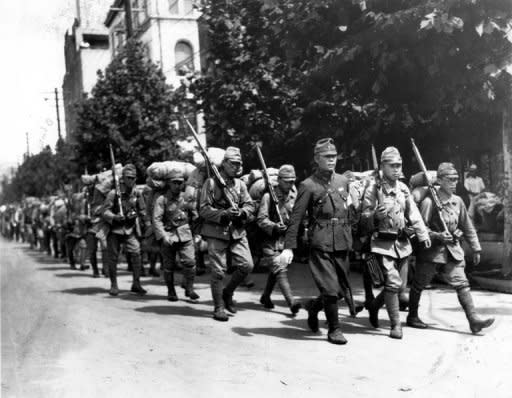 This picture received from the South Korean newspaper Dong-A Ilbo shows Japanese soldiers marching along a street in Seoul. South Korea has postponed at the last minute the signing of a landmark military agreement with Japan, amid anger in Seoul over the planned pact with a former colonial ruler