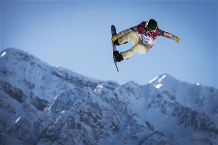 U.S. snowboarder White goes off a jump during snowboard slopestyle training at the 2014 Sochi Winter Olympics in Rosa Khutor