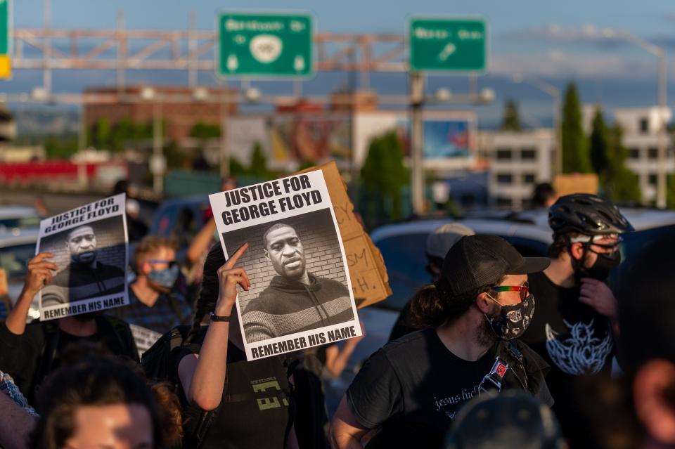 A sign calls for justice for George Floyd as the several thousand strong march walks on in direction of downtown Portland, OR, on June 3, 2020. The protest was organized to voice concerns over police brutality in the aftermath of the recent death of George Floyd, an African-American man from Minnesota, who died in police custody on May 25, 2020.