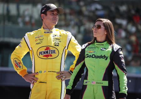 May 27, 2018; Indianapolis, IN, USA; IndyCar Series drivers Danica Patrick (right) and Helio Castroneves (left) are introduced before the 102nd Running of the Indianapolis 500 at Indianapolis Motor Speedway. Mandatory Credit: Brian Spurlock-USA TODAY Sports