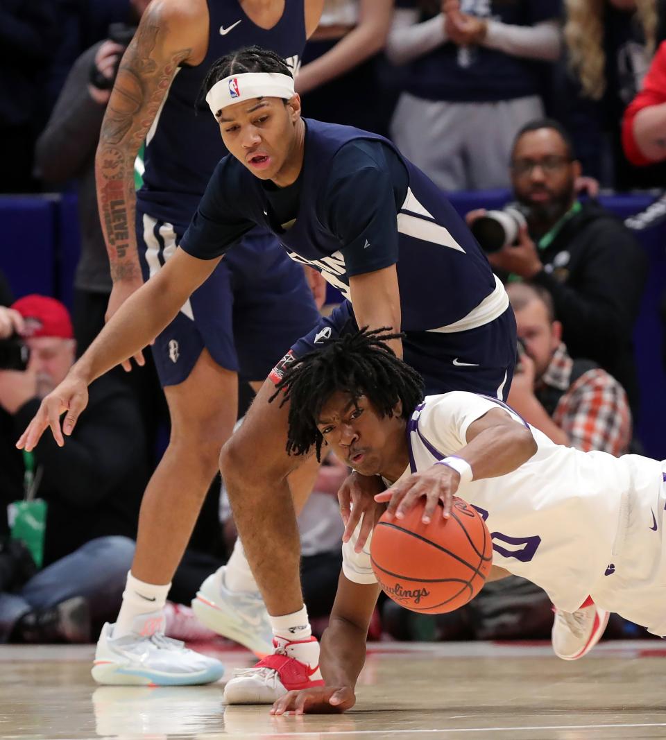 Hoban guard William Scott Jr., top, makes a play for a loose ball against Pickerington Central's Amare Spiva during the first half of the OHSAA Division I state final, Sunday, March 19, 2023, in Dayton.