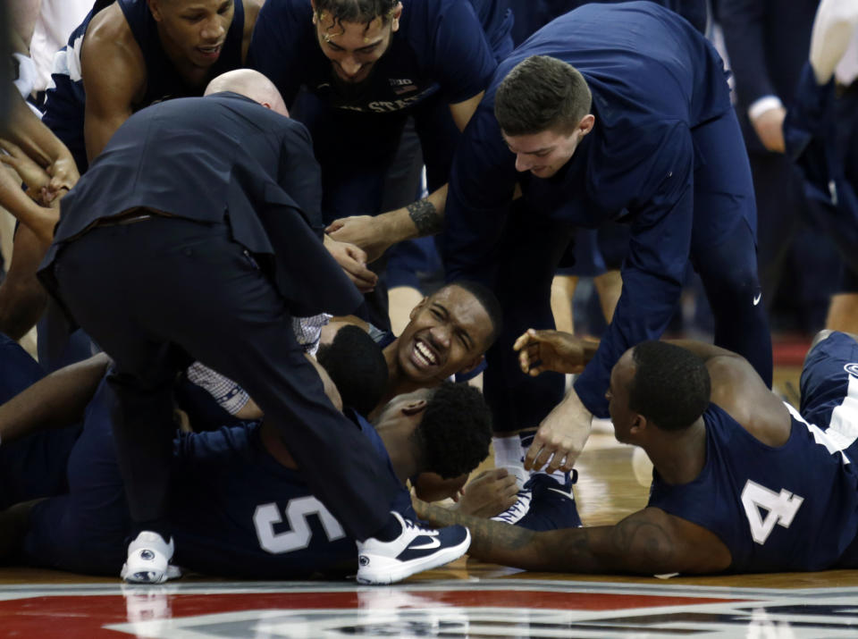Penn State guard Tony Carr, center, celebrates with teammates after his winning basket against Ohio State. (AP Photo/Paul Vernon)
