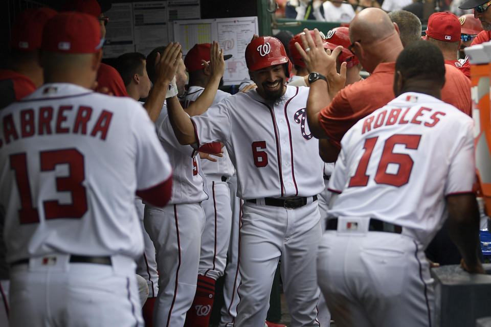 Washington Nationals' Anthony Rendon (6) celebrates his three-run home run in the dugout during the third inning of a baseball game against the Milwaukee Brewers, Sunday, Aug. 18, 2019, in Washington. (AP Photo/Nick Wass)