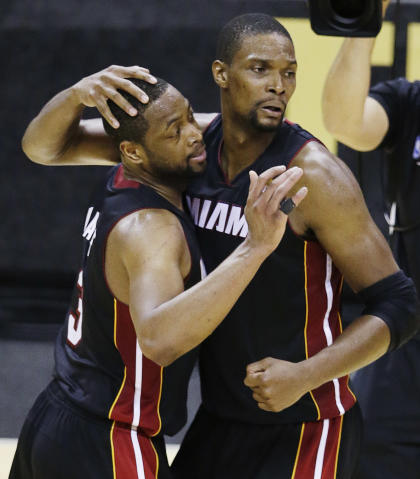 Chris Bosh and Dwyane Wade share a moment after helping the Heat beat the Spurs in Game 2. (AP) 