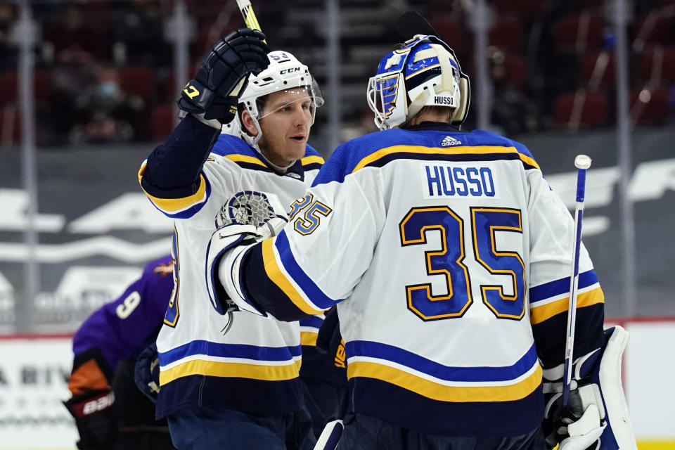 St. Louis Blues goaltender Ville Husso celebrates with teammate Austin Poganski (53) after defeating the Arizona Coyotes in overtime during an NHL hockey game, Saturday, Feb. 13, 2021, in Glendale, Ariz. (AP Photo/Rick Scuteri)