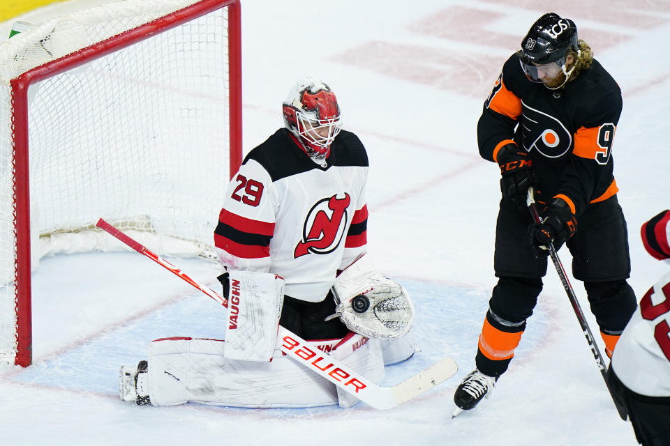 New Jersey Devils' Mackenzie Blackwood, left, blocks a shot past Philadelphia Flyers' Jakub Voracek during the third period of an NHL hockey game, Saturday, May 1, 2021, in Philadelphia. (AP Photo/Matt Slocum)