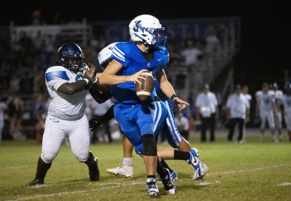 Valley Christian Trojans quarterback Gunnar Link (5) runs the ball at Valley Christian High School football stadium in Chandler on Sept. 22, 2023.