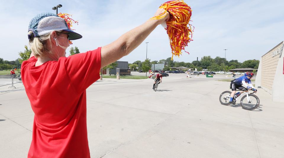 A volunteer greets RAGBRAI riders as they enter Jack Trice Stadium to finish the Day 3 of the ride on Tuesday in Ames.