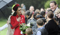 Britain's Kate, the Duchess of Cambridge, interacts with school children at the official welcome ceremony at Government House, in Wellington, New Zealand, Monday, April 7, 2014. Britain's Prince William and his wife, Kate, have arrived in New Zealand's capital to cheers from locals who braved windy, rainy weather to catch a glimpse of the royal couple. (AP Photo/SNPA, Ross Setford) NEW ZEALAND OUT