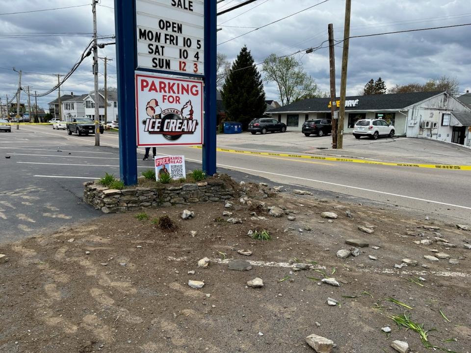 Debris near sign in ice cream parlor's parking lot