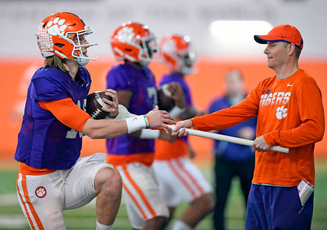 Clemson quarterbacks coach Brandon Streeter runs a drill with quarterback Trevor Lawrence (16) during the Tiger’s spring practice Monday, March 2, 2020.