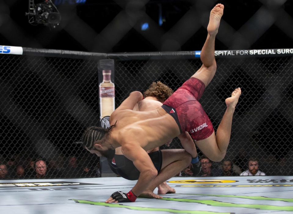 Jorge Masvidal, lands a flying knee on Ben Askren at the start of their welterweight mixed martial arts bout at UFC 239, Saturday, July 6, 2019, in Las Vegas. Masvidal won by the fastest knockout in UFC history. (AP Photo/Eric Jamison)