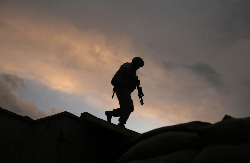 FILE - In this Sept. 18, 2009, file, photo, A soldier from the U.S. Army's 118th Military Police Co., based at Fort Bragg, N.C., respond to shots fired at a combat outpost in the Jalrez Valley in Afghanistan's Wardak Province. Moscow and Washington are intertwined in a complex and bloody history in Afghanistan, with both suffering thousands of dead and wounded in conflicts lasting for years. Now both superpowers are linked again over Afghanistan, with intelligence reports indicating Russia secretly offered bounties to the Taliban to kill American troops there. But analysts suggest that the two adversaries actually have more in common, especially when it comes to what they want to see in a postwar Afghanistan: a stable country that does not serve as a base for extremists to export terrorism. Both countries also are aligned in their opposition to militants from the Islamic State group.(AP Photo/Maya Alleruzzo, File)