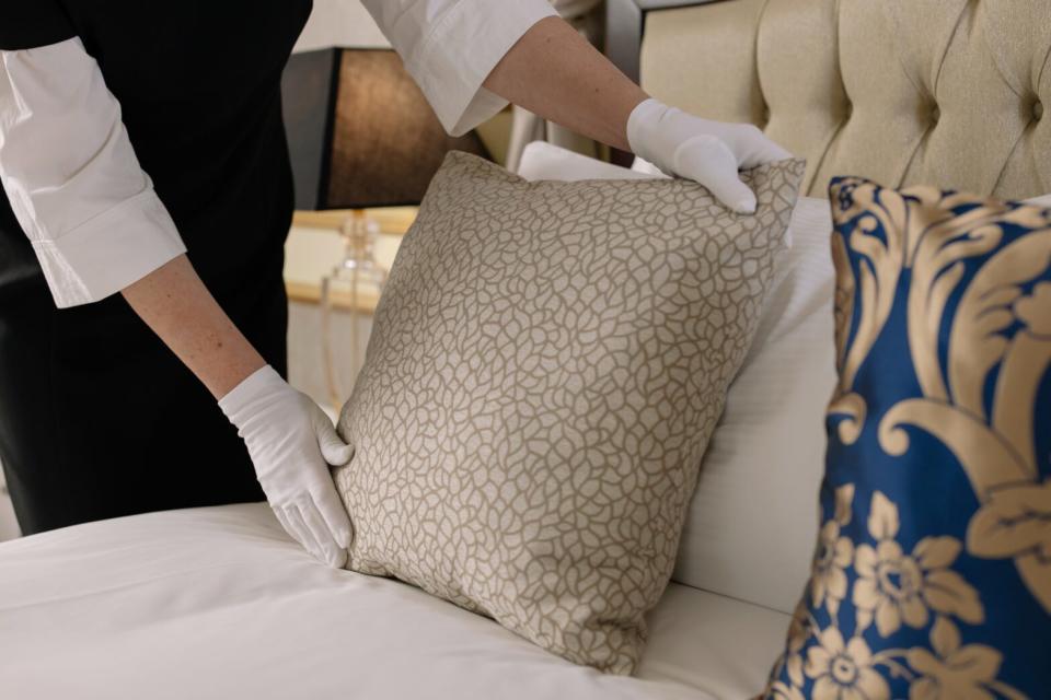 Woman Straightening Pillow