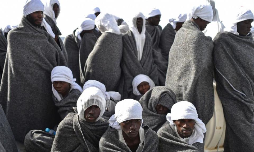 People protect themselves from the cold aboard the rescue ship Aquarius