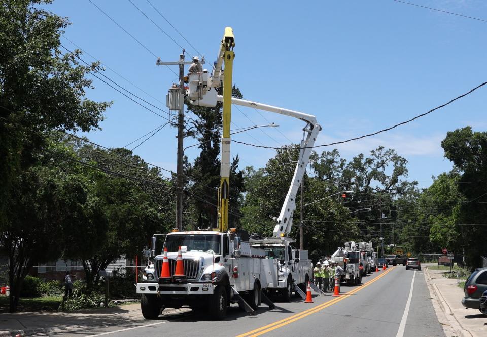 A crew from Dothan, Alabama works on a utility pole on Stuckey Avenue on Saturday afternoon.