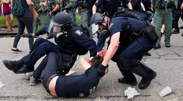 Police tackle demonstrator in in Baton Rouge, Louisiana on  July 10, 2016. Photo: Reuters/Shannon Stapleton