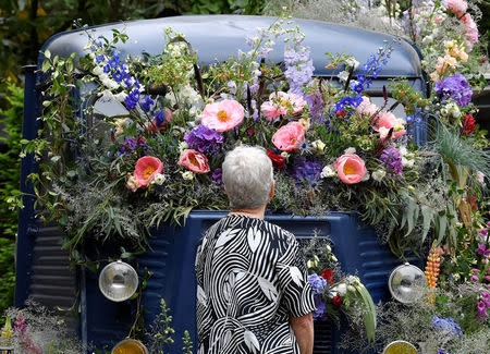 A woman views a floral display on a Citroen H-Van at the RHS Chelsea Flower Show in London, Britain, May 21, 2018. REUTERS/Toby Melville