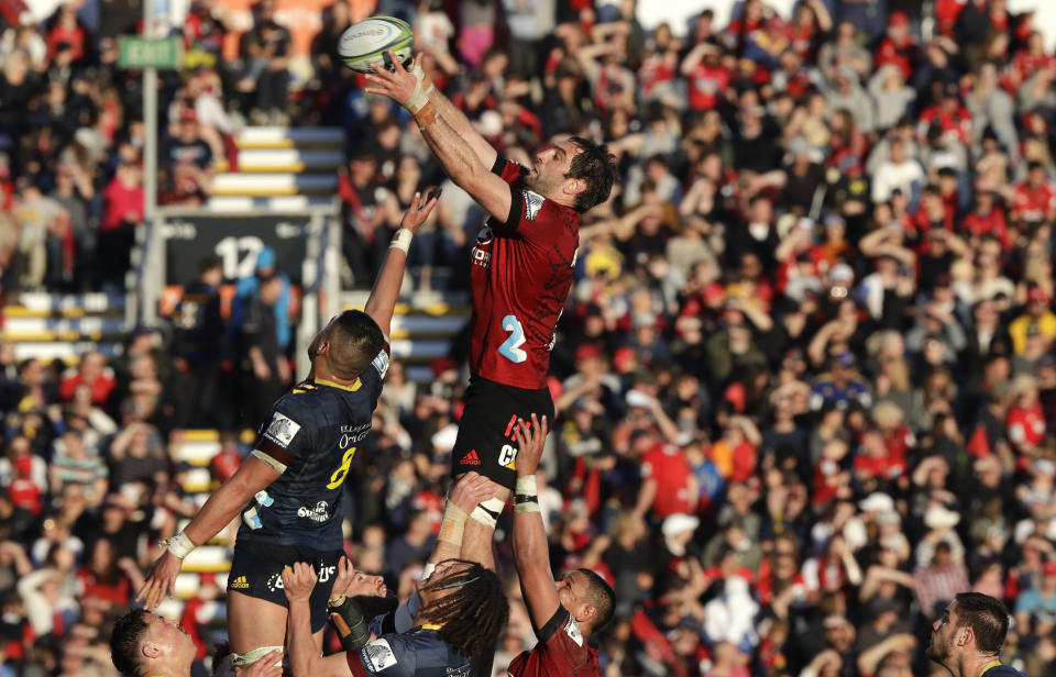 Crusaders Samuel Whitelock reaches for the ball to win a line out during the Super Rugby Aotearoa rugby game between the Crusaders and the Highlanders in Christchurch, New Zealand, Sunday, Aug. 9, 2020. (AP Photo/Mark Baker)