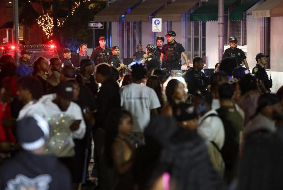 Police begin to clear people off of Eighth Street and Ocean Drive to prepare for the 11:59 p.m. curfew that was imposed on Sunday, March 19, 2023, in Miami Beach.