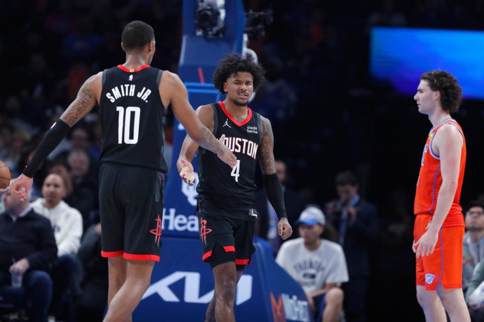 Houston Rockets guard Jalen Green (4) and Houston Rockets forward Jabari Smith Jr. (10) celebrate beside Oklahoma City Thunder guard Josh Giddey (3) during an NBA basketball game between the Oklahoma City Thunder and the Houston Rockets at Paycom Center in Oklahoma City, Wednesday, March 27, 2024. Houston won 132-126.