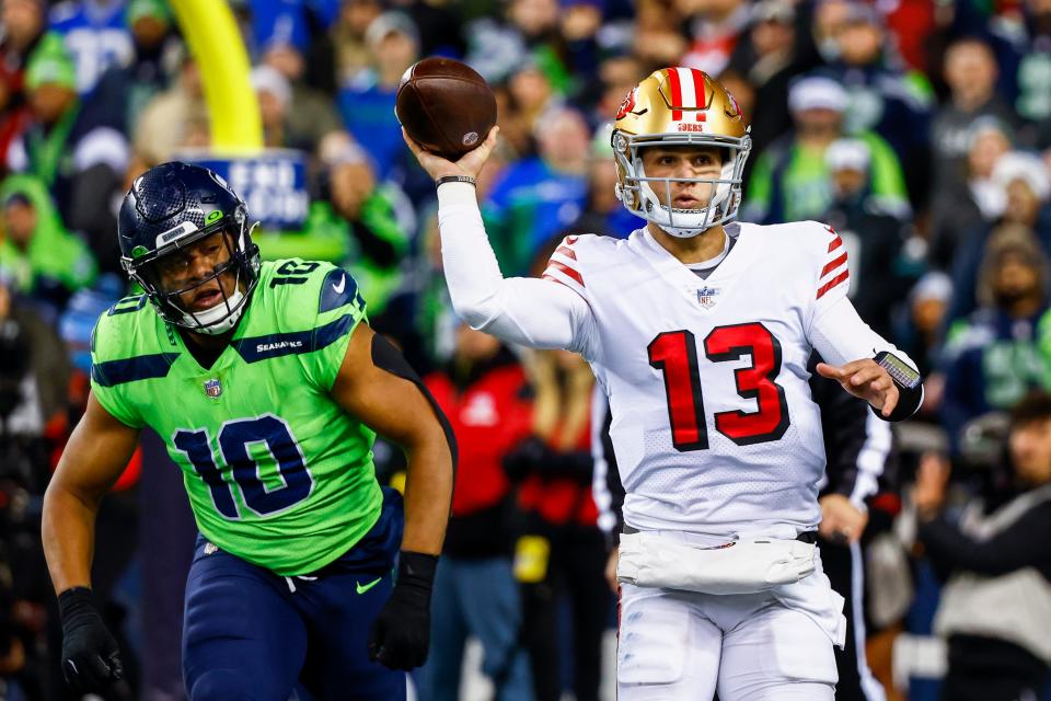 San Francisco 49ers quarterback Brock Purdy (13) passes in front of Seattle Seahawks linebacker Uchenna Nwosu (10) during the fourth quarter at Lumen Field earlier this season.