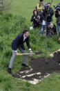 Chairman of London Organising Committee of the Olympic and Paralympic Games, Sebastian Coe plants an oak tree at Kew Royal Botanic Gardens in London to mark 100 days before the start of the London 2012 Olympic Games, Wednesday, April 18, 2012. The opening ceremony will take place on July 27, 2012. (AP Photo/Sang Tan)