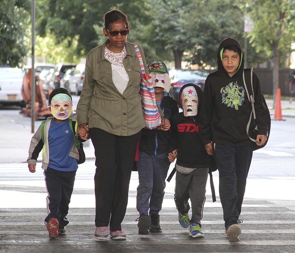 <p>Immigrant children separated from parents who were detained at the U.S./Mexico border arrive Cayuga Center, a foster care facility, in East Harlem wearing masks, hats and sunglasses in New York City on June 22, 2018. (Photo: Rainmaker Photo/MediaPunch/IPX/AP) </p>