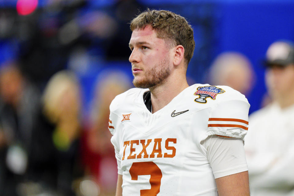 FILE - Texas quarterback Quinn Ewers (3) warms up before the Sugar Bowl CFP NCAA semifinal college football game against Washington, Monday, Jan. 1, 2024, in New Orleans. The quarterback pecking order for the 2025 NFL draft still seems fluid going into this college football season, with Ewers, Georgia's Carson Beck, and Colorado's Shedeur Sanders getting the most preseason buzz. (AP Photo/Jacob Kupferman, File)