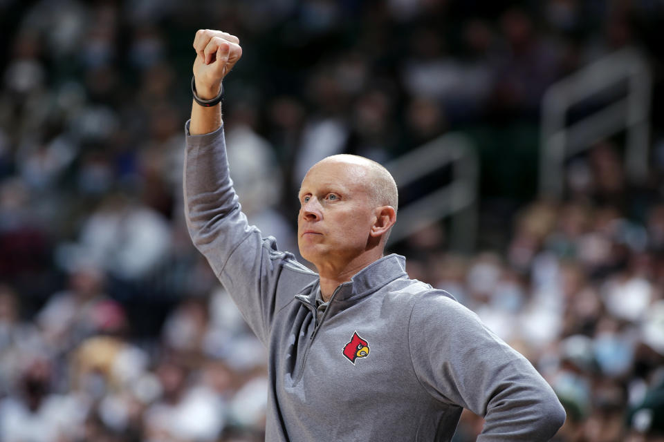 Louisville coach Chris Mack signals during the first half of the team's NCAA college basketball game against Michigan State, Wednesday, Dec. 1, 2021, in East Lansing, Mich. (AP Photo/Al Goldis)