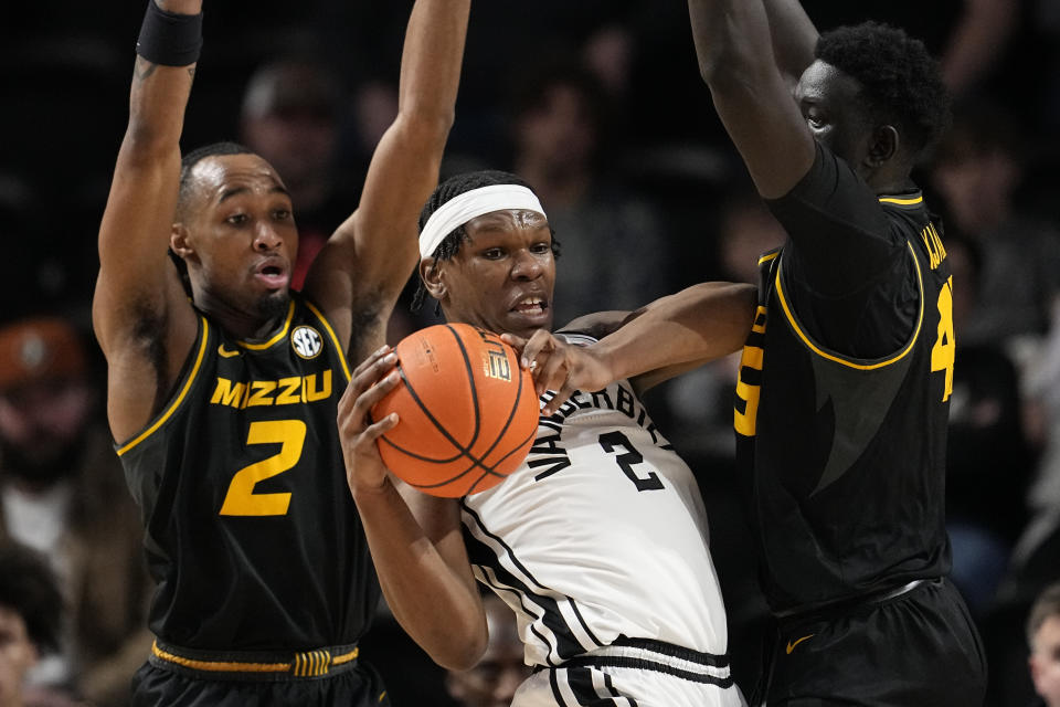 Vanderbilt forward Ven-Allen Lubin (2) looks to pass the ball past Missouri guard Tamar Bates (2) and center Mabor Majak, right, during the first half of an NCAA college basketball game Saturday, Feb. 3, 2024, in Nashville, Tenn. (AP Photo/George Walker IV)