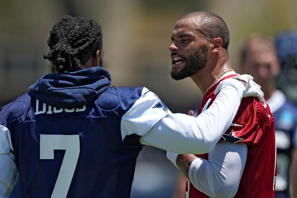 Dallas Cowboys cornerback Trevon Diggs, left, and quarterback Dak Prescott have a conversation during the NFL football team's training camp Wednesday, July 26, 2023, in Oxnard, Calif.