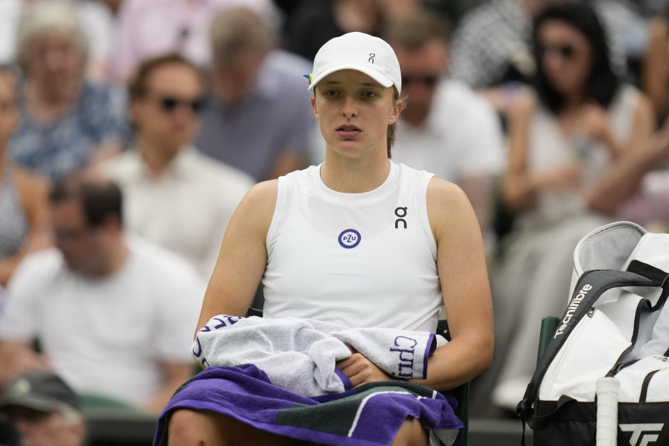 Poland's Iga Swiatek sits in her chair during a change of ends break as she plays Ukraine's Elina Svitolina in a women's singles match on day nine of the Wimbledon tennis championships in London, Tuesday, July 11, 2023. (AP Photo/Kirsty Wigglesworth)
