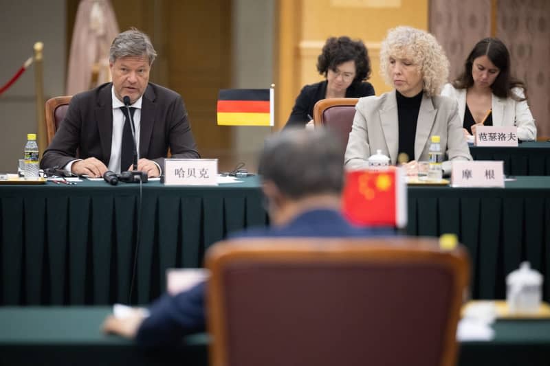 Robert Habeck (L), Germany's Minister for Economic Affairs and Climate Protection, speaks during the Sino-German Climate and Transformation Dialogue with the National Reform and Development Commission as part of a visit to the People's Republic of China. Sebastian Christoph Gollnow/dpa